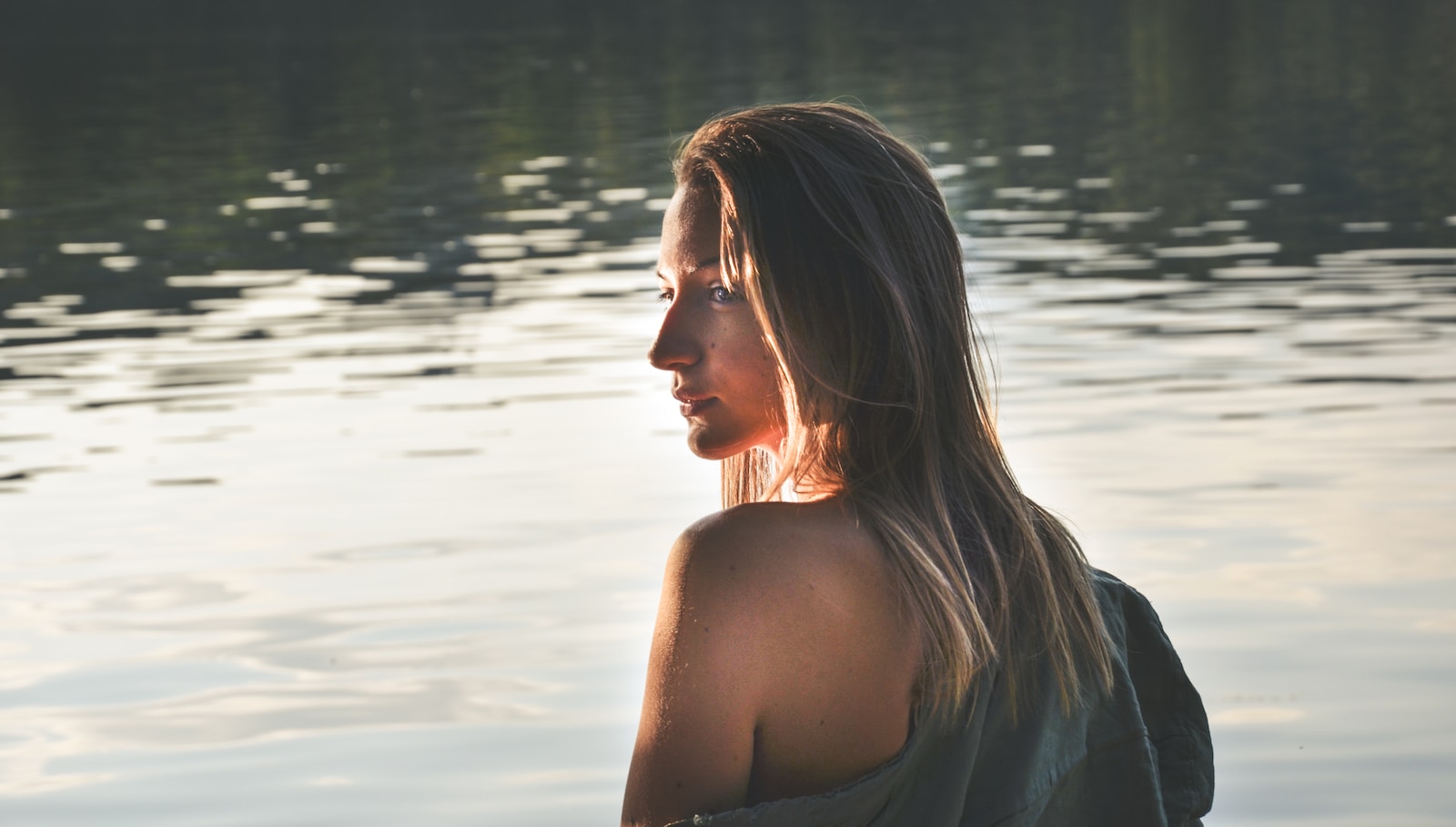 woman with blonde hair on body of water